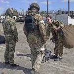 
              In this photo taken from video released by the Russian Defense Ministry Press Service on Wednesday, May 18, 2022, Russian servicemen frisk Ukrainian servicemen after they leaved the besieged Azovstal steel plant in Mariupol, Ukraine.(Russian Defense Ministry Press Service via AP)
            