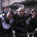
              Israeli police detain a man during the funeral for slain Al Jazeera veteran journalist Shireen Abu Akleh in the Old City of Jerusalem, Friday, May 13, 2022. Abu Akleh, a Palestinian-American reporter who covered the Mideast conflict for more than 25 years, was shot dead Wednesday during an Israeli military raid in the West Bank town of Jenin.(AP Photo/Mahmoud Illean)
            