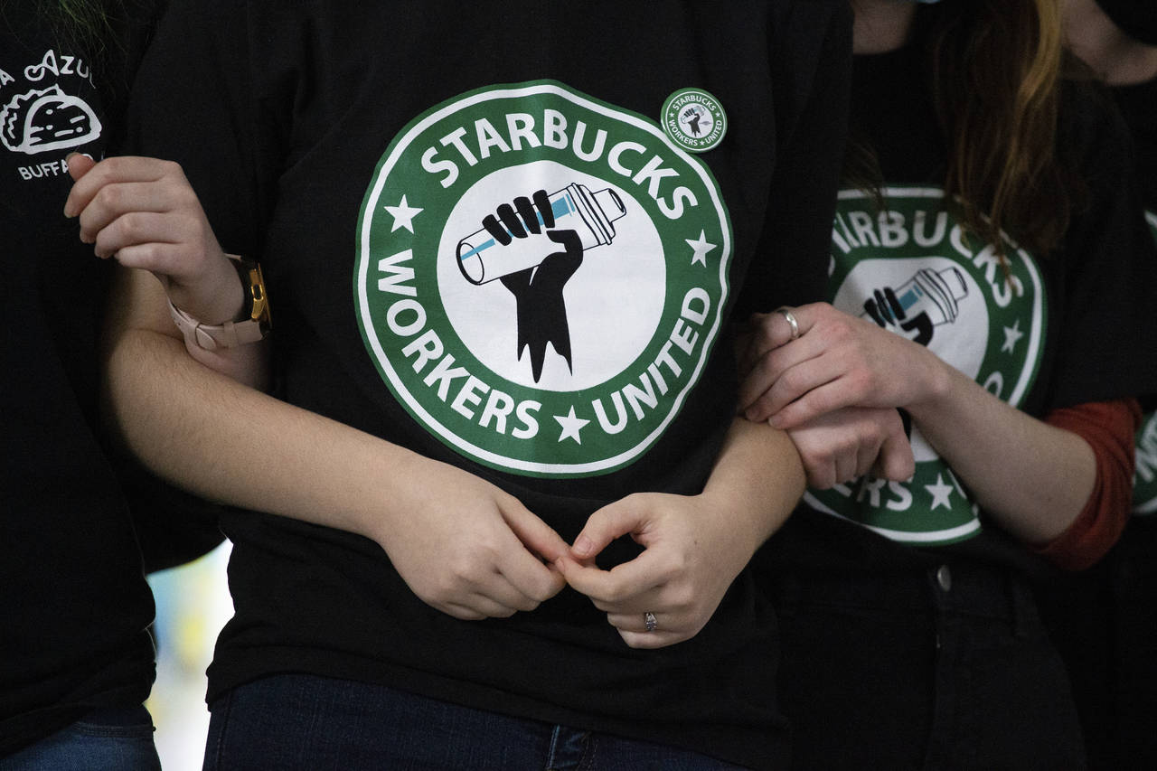 FILE - Starbucks employees and supporters react as votes are read during a union-election watch par...