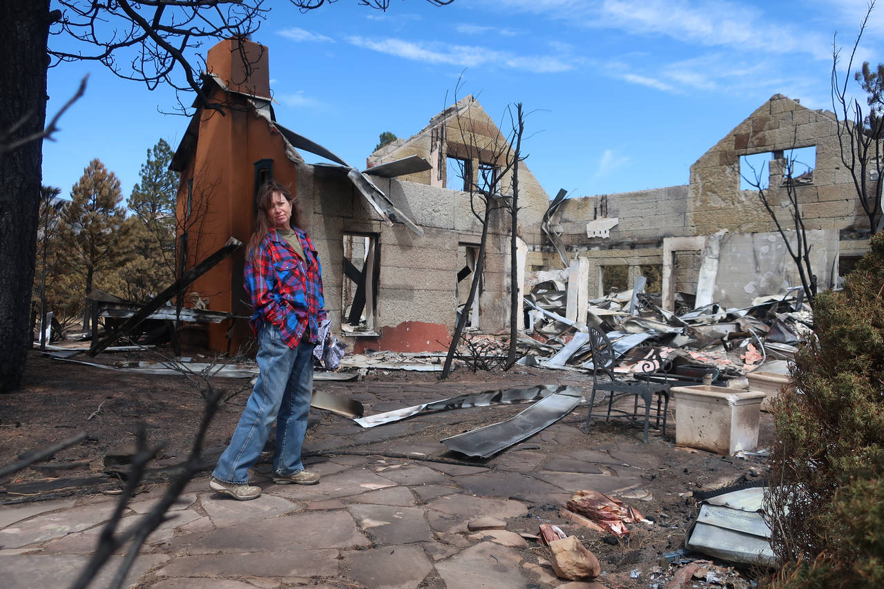 Jeanne Welnick stands amid the ruins of her home on the outskirts of Flagstaff, Ariz., Thursday, Ap...