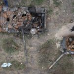 
              A man passes by Russian tanks destroyed in a recent battle against Ukrainians in the village of Dmytrivka, close to Kyiv, Ukraine, Monday, May 23, 2022. (AP Photo/Efrem Lukatsky)
            