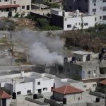 
              Smoke rises from a home during an Israeli military operation in the West Bank town of Jenin, Friday, May 13, 2022. Israeli troops pushed into Jenin early Friday following the death of veteran Al Jazeera correspondent Serine Abu Akleh on Wednesday when she was shot dead by Israeli forces while covering a military operation in the occupied West Bank. (AP Photo/Majdi Mohammed)
            