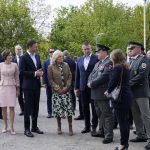 
              First lady Jill Biden listens as Robert Gucky, Slovakia's Director of the Border and Foreign Police Office, Presidium of the Police Force, third from right, speaks after walking from Vysne Nemecke, Slovakia, across the border with Ukraine, red line, during a visit Sunday, May 8, 2022. From left, Slovakia Prime Minister Eduard Heger's spouse Lucia Hegerova, Heger, Biden, Minister of the Interior of Slovakia Roman Mikulec, and Gucky. (AP Photo/Susan Walsh, Pool)
            