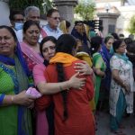 
              Relatives mourn during the cremation of Rahul Bhat, a government employee killed on Thursday, in Jammu, India, Friday, May 13, 2022. Bhat, who was a minority Kashmiri Hindu known as "pandits," was killed by suspected rebels inside his office in Chadoora town in the Indian portion of Kashmir. (AP Photo/Channi Anand)
            