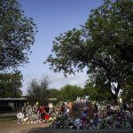 People visit a memorial at Robb Elementary School in Uvalde, Texas, Tuesday, May 31, 2022, to honor the victims killed in last week's school shooting. (AP Photo/Jae C. Hong)