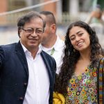 
              Gustavo Petro, left, presidential candidate with the Historical Pact coalition, makes the victory sign as he arrives to a polling station with his daughter, Sofia Petro, to vote during presidential elections in Bogota, Colombia, Sunday, May 29, 2022. (AP Photo/Fernando Vergara)
            