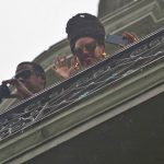 
              FILE - Beyonce waves to fans as her husband, rapper Jay-Z takes photos from a balcony at the Saratoga Hotel in Old Havana, Cuba, April 5, 2013. A powerful explosion apparently caused by a natural gas leak Friday, May 6, 2022, killed at least nine people and and injured dozens when it blew away outer walls from the luxury hotel in the heart of Cuba’s capital. (AP Photo/Ramon Espinosa, File)
            