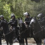 
              Israeli mounted police in riot gear stage outside of the hospital where the body of slain Al Jazeera veteran journalist Shireen Abu Akleh will be taken from to to her final resting place, in east Jerusalem, Friday, May 13, 2022. Abu Akleh, a Palestinian-American reporter who covered the Mideast conflict for more than 25 years, was shot dead Wednesday during an Israeli military raid in the West Bank town of Jenin.(AP Photo/Mahmoud Illean)
            