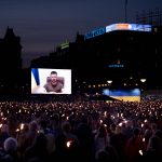 
              People gather to watch Ukrainian President Volodymyr Zelenskyy speak on a screen at the City Hall Square in Copenhagen, Wednesday May 4, 2022. (Liselotte Sabroe/Ritzau Scanpix via AP)
            