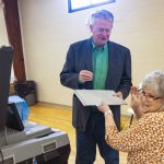 
              Idaho Gov. Brad Little laughs as he takes an "I Voted" sticker from poll worker Carla Stark after casting his ballot in Idaho's Primary Election in Emmett, Idaho, Tuesday, May 17, 2022. (AP Photo/Kyle Green)
            