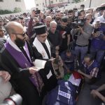 
              Journalists surround the body of Shireen Abu Akleh, a journalist for Al Jazeera network, into the morgue inside the Hospital in the West Bank town of Jenin, Wednesday, May 11, 2022. The well-known Palestinian reporter for the broadcaster's Arabic language channel was shot and killed while covering an Israeli raid in the occupied West Bank town of Jenin early Wednesday, the Palestinian health ministry said. (AP Photo/Majdi Mohammed)
            