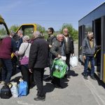 
              People board a bus during an evacuation of civilians on a road near Slovyansk, eastern Ukraine, Wednesday, May 4, 2022. (AP Photo/Andriy Andriyenko)
            