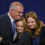 
              Australian Prime Minister Scott Morrison hugs his daughters Lily and Abbey at a Liberal Party function in Sydney, Australia, Saturday, May 21, 2022. Morrison has conceded defeat and has confirmed that he would hand over the leadership of the Liberal Party following his party's loss to Labor in today's federal election. (AP Photo/Mark Baker)
            