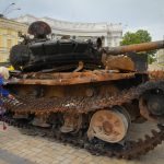
              A woman looks at a destroyed Russian tank installed as a symbol of war in central Kyiv, Ukraine, Friday, May 20, 2022. (AP Photo/Efrem Lukatsky)
            