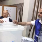 
              In this photo released by Lebanon's official government photographer Dalati Nohra, Lebanese President Michel Aoun, left, casts his vote in Lebanon's parliamentary elections, at a polling station, in Beirut, Lebanon, Sunday, May 15, 2022. (Dalati Nohra via AP)
            