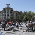 
              Local residents gather to charge their mobile devices from a generator brought by Donetsk People Republic Emergency Situations Ministry in Mariupol, in territory under the government of the Donetsk People's Republic, eastern Ukraine, Thursday, May 12, 2022. (AP Photo)
            