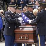 Members of the Utah Army National Guard fold the American flag that drapes the casket of former Utah Sen. Orrin Hatch during funeral services at The Church of Jesus Christ of Latter-day Saints' Institute of Religion Friday, May 6, 2022, in Salt Lake City. Hatch, the longest-serving Republican senator in history and a fixture in Utah politics for more than four decades, died last month at the age of 88. (AP Photo/Rick Bowmer)