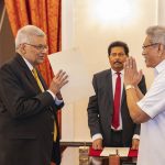 
              In this handout photograph provided by the Sri Lankan President's Office, President Gotabaya Rajapaksa, right, greets Ranil Wickremesinghe during the latter's oath taking ceremony as the new prime minister in Colombo, Sri Lanka, Thursday, May 12, 2022. Wickremesinghe has been reappointed in an effort to bring stability to the island nation engulfed in a political and economic crisis. (Sri Lankan President's Office via AP)
            