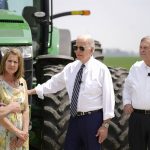 
              FILE - President Joe Biden listens as he stands with O'Connor Farms owners Jeff O'Connor, left, and Gina O'Connor, second from left, and Agriculture Secretary Tom Vilsack, right, at the farm May 11, 2022, in Kankakee, Ill.  While the primaries are testing Trump’s grip on the GOP, they’re also serving as a barometer of Biden’s ability to shape the Democratic Party. (AP Photo/Andrew Harnik, File)
            
