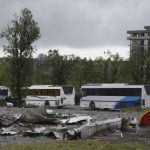 
              Buses wait for Ukrainian servicemen to transport them from Mariupol to a prison in Olyonivka after they leave the besieged Mariupol's Azovstal steel plant, in Mariupol, in territory under the government of the Donetsk People's Republic, eastern Ukraine, Wednesday, May 18, 2022. (AP Photo)
            