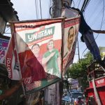 
              Village workers remove a campaign poster showing Presidential candidate Ferdinand "Bongbong" Marcos Jr. and running mate Sara Duterte along a street in Quezon city, Philippines on Wednesday, May 11, 2022. Marcos, the namesake son of longtime dictator Ferdinand Marcos, apparent landslide victory in the Philippine presidential election is raising immediate concerns about a further erosion of democracy in Asia and could complicate American efforts to blunt growing Chinese influence and power in the Pacific. (AP Photo/Aaron Favila)
            