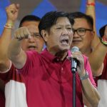 
              FILE - Presidential hopeful, former senator Ferdinand "Bongbong" Marcos Jr., the son of the late dictator, gestures as he greets the crowd during a campaign rally in Quezon City, Philippines on April 13, 2022. Marcos Jr.'s apparent landslide victory in the Philippine presidential election is giving rise to immediate concerns about a further erosion of democracy in the region, and could complicate American efforts to blunt growing Chinese influence and power in the Pacific. (AP Photo/Aaron Favila, File)
            