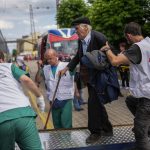 
              An elderly man boards a medical evacuation train run by MSF (Doctors Without Borders) at the train station in Pokrovsk, eastern Ukraine, Sunday, May 29, 2022. The train is specially equipped and staffed with medical personnel, and ferries patients from overwhelmed hospitals near the front line, to medical facilities in western Ukraine, far from the fighting. (AP Photo/Francisco Seco)
            