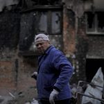 
              Anatolii Chovpin stands outside the damagde building where he lives ruined by attacks in Irpin, on the outskirts of Kyiv, Ukraine, Thursday, May 26, 2022. (AP Photo/Natacha Pisarenko)
            