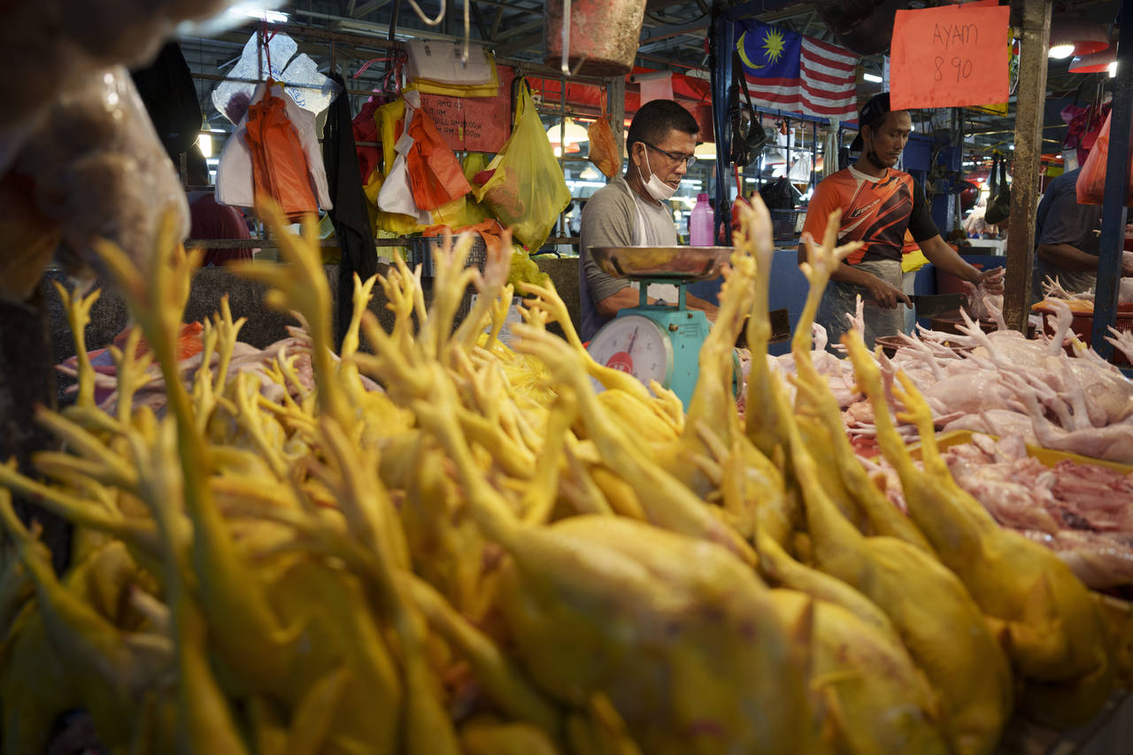 A seller prepares freshly butchered chickens at the Kampung Baru wet market in Kuala Lumpur, Malays...