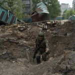 
              A special task force policeman inspects a site after an airstrike by Russian forces in Lysychansk, Luhansk region, Ukraine, Friday, May 13, 2022. (AP Photo/Leo Correa)
            