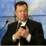 
              FILE - Elon Musk founder, CEO, and chief engineer/designer of SpaceX jokes with reporters as he pretends to search for an answer to a question on a cell phone during a news conference after a Falcon 9 SpaceX rocket test flight to demonstrate the capsule's emergency escape system at the Kennedy Space Center in Cape Canaveral, Fla., Sunday, Jan. 19, 2020.  Many people are puzzled on what a Elon Musk takeover of Twitter would mean for the company and even whether he’ll go through with the deal.  If the 50-year-old Musk’s gambit has made anything clear it’s that he thrives on contradiction. (AP Photo/John Raoux, File)
            
