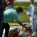 
              A woman pays her respects at a memorial site for the victims killed in this week's shooting at Robb Elementary School in Uvalde, Texas, Friday, May 27, 2022. (AP Photo/Dario Lopez-Mills)
            