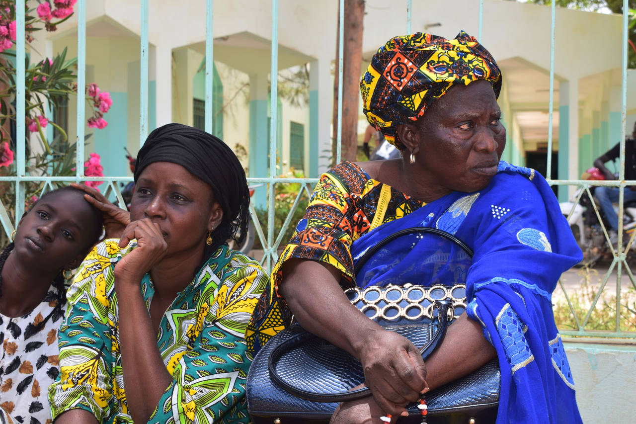 Relatives sit outside the Abdoul Aziz Sy Dabakh Hospital in Tivaouane, Senegal, a town 90 kms ( 60 ...