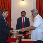 
              In this handout photograph provided by the Sri Lankan President's Office, President Gotabaya Rajapaksa, right, hands over the appointment document to Gamini Lakshman Peiris after he took oath of office as the new foreign minister in Colombo, Sri Lanka, Saturday, May 14, 2022. (Sri Lankan President's Office via AP)
            