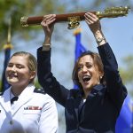 
              Vice President Kamala Harris lifts the school scepter at the conclusion of the U.S. Coast Guard Academy's 141st Commencement Exercises Wednesday, May 18, 2022 in New London, Conn. At left is Carolyn Ziegler, the last cadet of the 250 to graduate.  (AP Photo/Stephen Dunn)
            