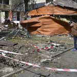 
              A man looks on parts of a missile collected next to an apartment building destroyed by night shelling in Kramatorsk, Ukraine, Thursday, May 5, 2022. (AP Photo/Andriy Andriyenko)
            