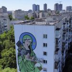 
              A worker paints a "Saint Javelin", a Virgin Mary holding an American-made anti-tank missile, in Kyiv, Ukraine, Tuesday, May 24, 2022. (AP Photo/Natacha Pisarenko)
            