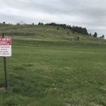 In this photo provided by Randi Oyan, is a hillside near the former Rapid City Indian School, in Rapid City, S.D., on Wednesday, May 11, 2022, that researchers say is the site of unmarked graves of children who died at the school, which operated from 1898 until 1933. A memorial is planned at the site. (AP Photo/Randi Oyan)