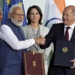 
              German Chancellor Olaf Scholz, right, and Indian Prime Minister Narendra Modi, left, shake hands after contract signing ceremony as part of a meeting at the chancellery in Berlin, Germany, Monday, May 2, 2022. (AP Photo/Michael Sohn)
            