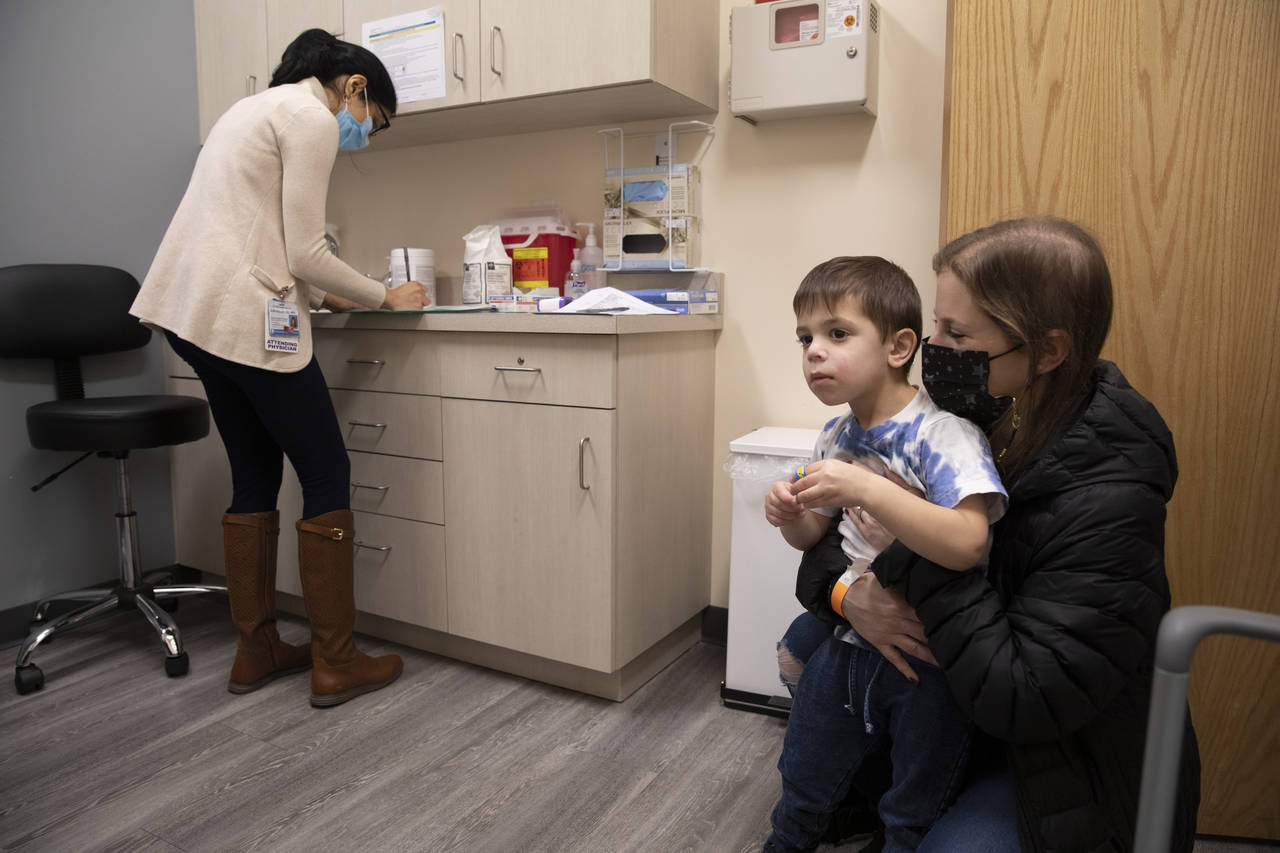 FILE - Ilana Diener holds her son, Hudson, 3, during an appointment for a Moderna COVID-19 vaccine ...