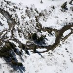 
              The Blue River, an important source of water for Denver and others along the Colorado River, is surrounded by snow, Monday, April 18, 2022, near Blue River, Colo. (AP Photo/Brittany Peterson)
            