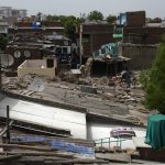 
              A white reflective painted rooftop which brings down indoor temperature in summer is seen in a shanty town, in Ahmedabad, India, Monday, May 23, 2022. The intense heat wave sweeping through South Asia was made more likely due to climate change and it is a sign of things to come. An analysis by international scientists said that this heat wave was made 30-times more likely because of climate change, and future warming would make heat waves more common and hotter in the future. (AP Photo/Ajit Solanki)
            