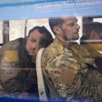 
              Ukrainian servicemen sit in a bus after they were evacuated from the besieged Mariupol's Azovstal steel plant, near a remand prison in Olyonivka, in territory under the government of the Donetsk People's Republic, eastern Ukraine, Tuesday, May 17, 2022. More than 260 fighters, some severely wounded, were pulled from a steel plant on Monday that is the last redoubt of Ukrainian fighters in the city and transported to two towns controlled by separatists, officials on both sides said. (AP Photo/Alexei Alexandrov)
            