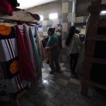 
              Iracema Figueroa, left, of Honduras, waits for her turn to take a shower at a shelter for migrants Friday, May 20, 2022, in Tijuana, Mexico. Figueroa has spent two years trying to reach a safe place for her family and was praying the judge would lift the order. Figueroa left Honduras in 2019 after gangs killed her uncle and threatened her three sons. (AP Photo/Gregory Bull)
            