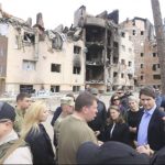 
              This image provided by the Irpin Mayor's Office shows Canadian Prime Minister Justin Trudeau, second from right, speaking with mayor Oleksandr Markushyn, center wearing t-shirt, in Irpin, Ukraine, Sunday, May 8, 2022. Trudeau made a surprise visit to Irpin on Sunday. The city was severely damaged during Russia’s attempt to take Kyiv at the start of the war. (Irpin Mayor's Office via AP)
            