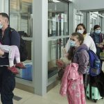 
              Ukrainian nationals fleeing the ongoing Russian invasion of Ukraine arrive at the Richardson International Airport, in Winnipeg, Manitoba, Monday, May 23, 2022. (David Lipnowski/The Canadian Press via AP)
            