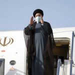 
              Iranian President Ebrahim Raisi waves to media and officials as he boards his plane departing Tehran's Mehrabad airport for a trip to Oman, Monday, May, 23, 2022. (AP Photo/Vahid Salemi)
            