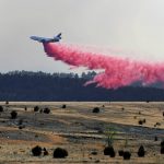 
              A firefighting airplane drops slurry on a wildfire near Las Vegas, N.M., on Tuesday, May 3, 2022. Flames raced across more of New Mexico's pine-covered mountainsides Tuesday, charring more than 217 square miles (562 square kilometers) over the last several weeks. (AP Photo/Thomas Peipert)
            