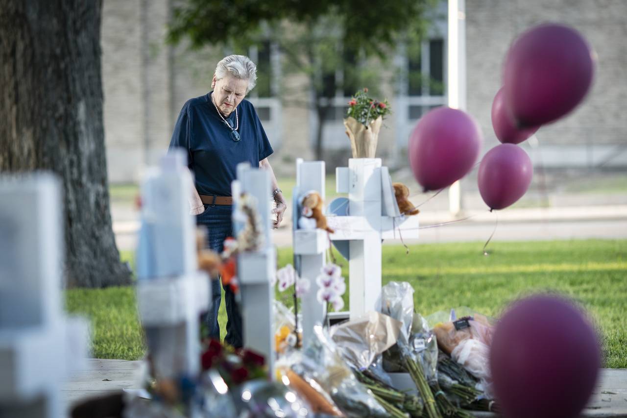 Eloise Castro, 75 a resident of Uvalde visits a memorial site to lay flowers and a candle in the to...