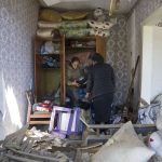 
              Women collect belongings in their apartment destroyed by Russian airstrike in Bakhmut, Donetsk region, Ukraine, Saturday, May 7, 2022. (AP Photo/Evgeniy Maloletka)
            